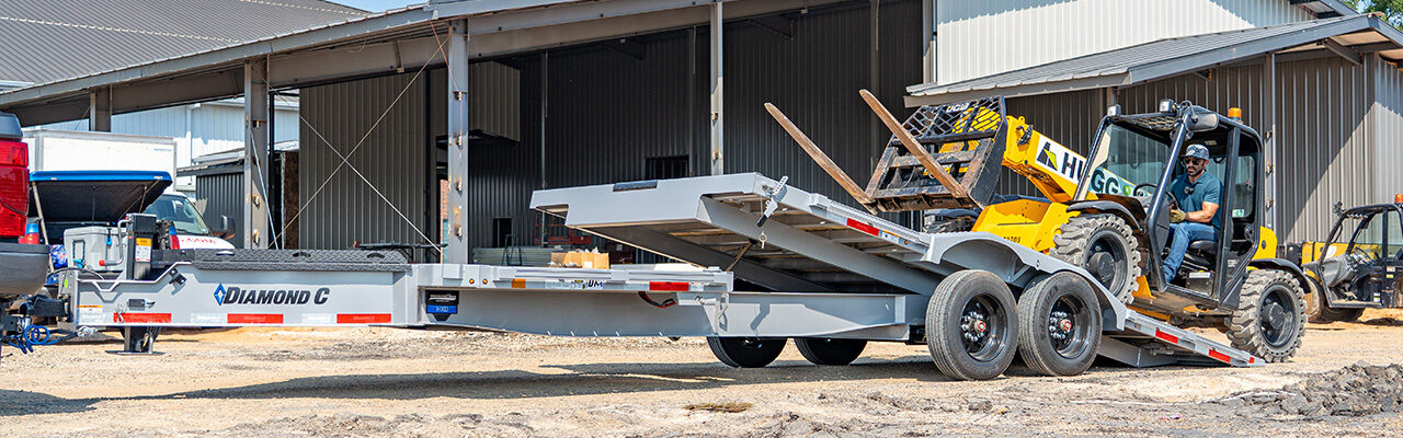 Diamond C equipment trailer with telehandler loading for sale in Texas at Trailer Place
