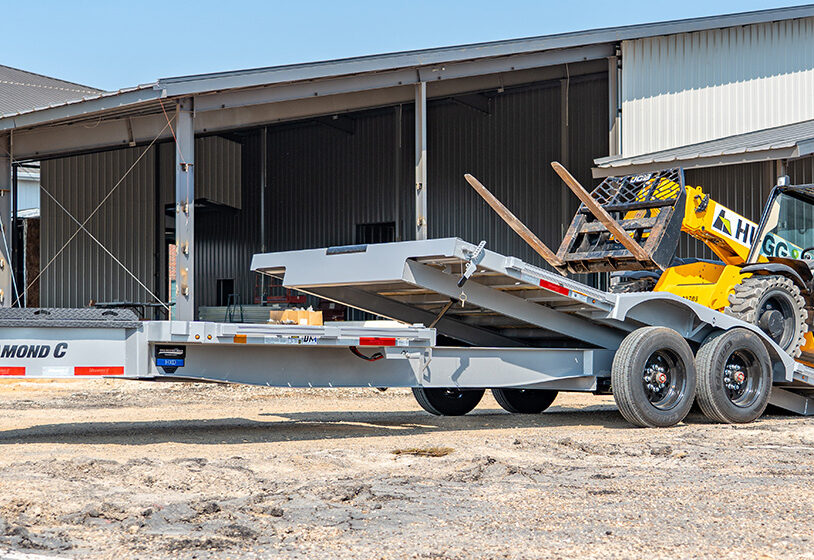 Diamond C equipment trailer with telehandler loading for sale in Texas at Trailer Place