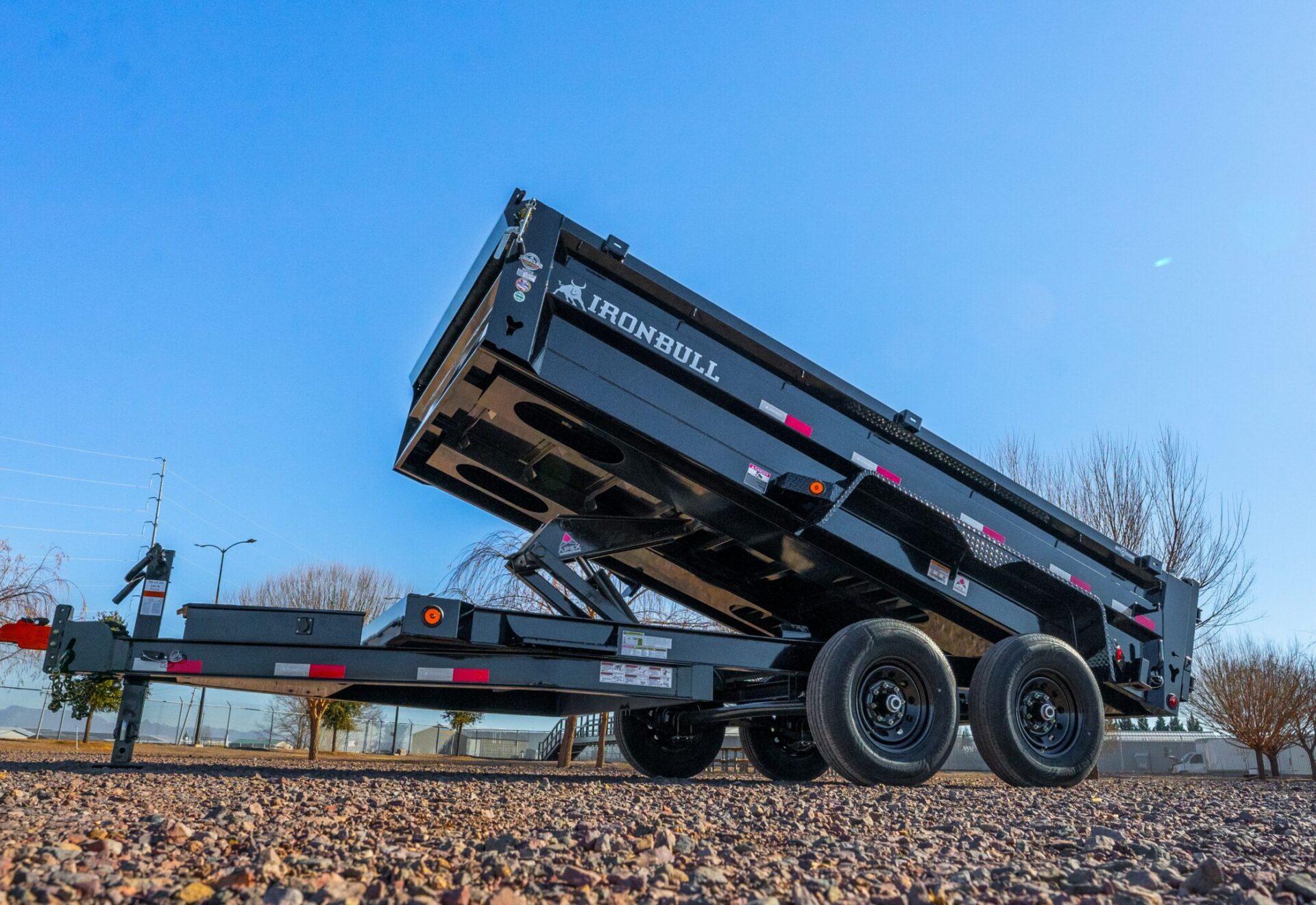 Iron Bull dump trailer with bed raised for sale in Texas at Trailer Place