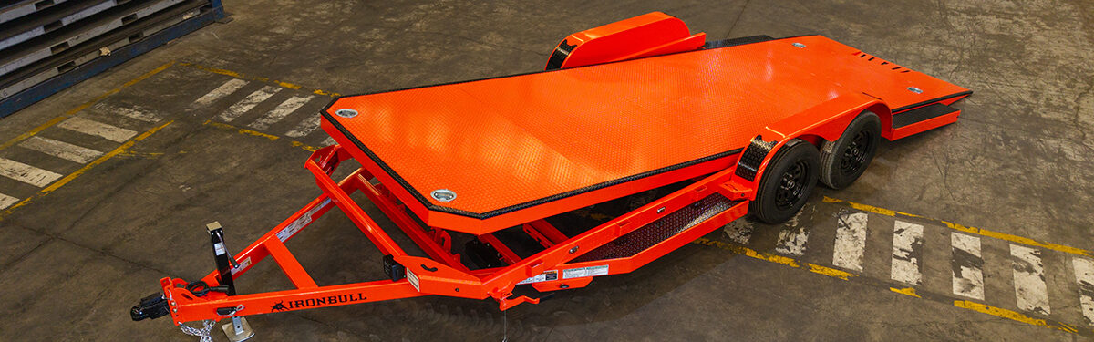 Iron Bull orange tilt equipment trailer for sale in Texas at Trailer Place