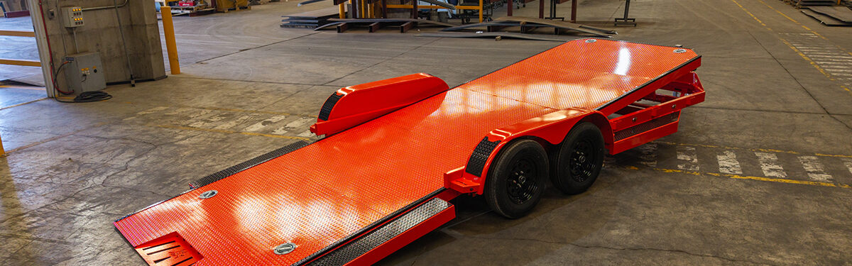 Iron Bull orange tilt trailer with ramp down for sale in Texas at Trailer Place